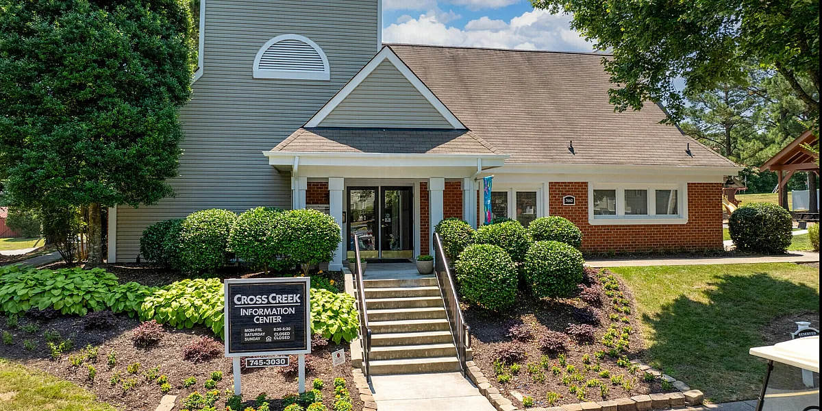 Elegant Cross Creek information center building surrounded by lush greenery and manicured landscaping.