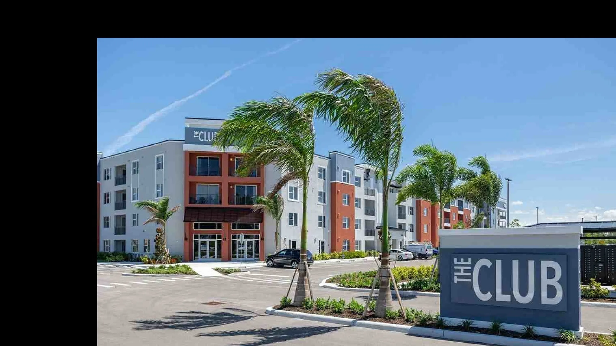 Modern apartment complex with vibrant exterior colors and landscaped surroundings.