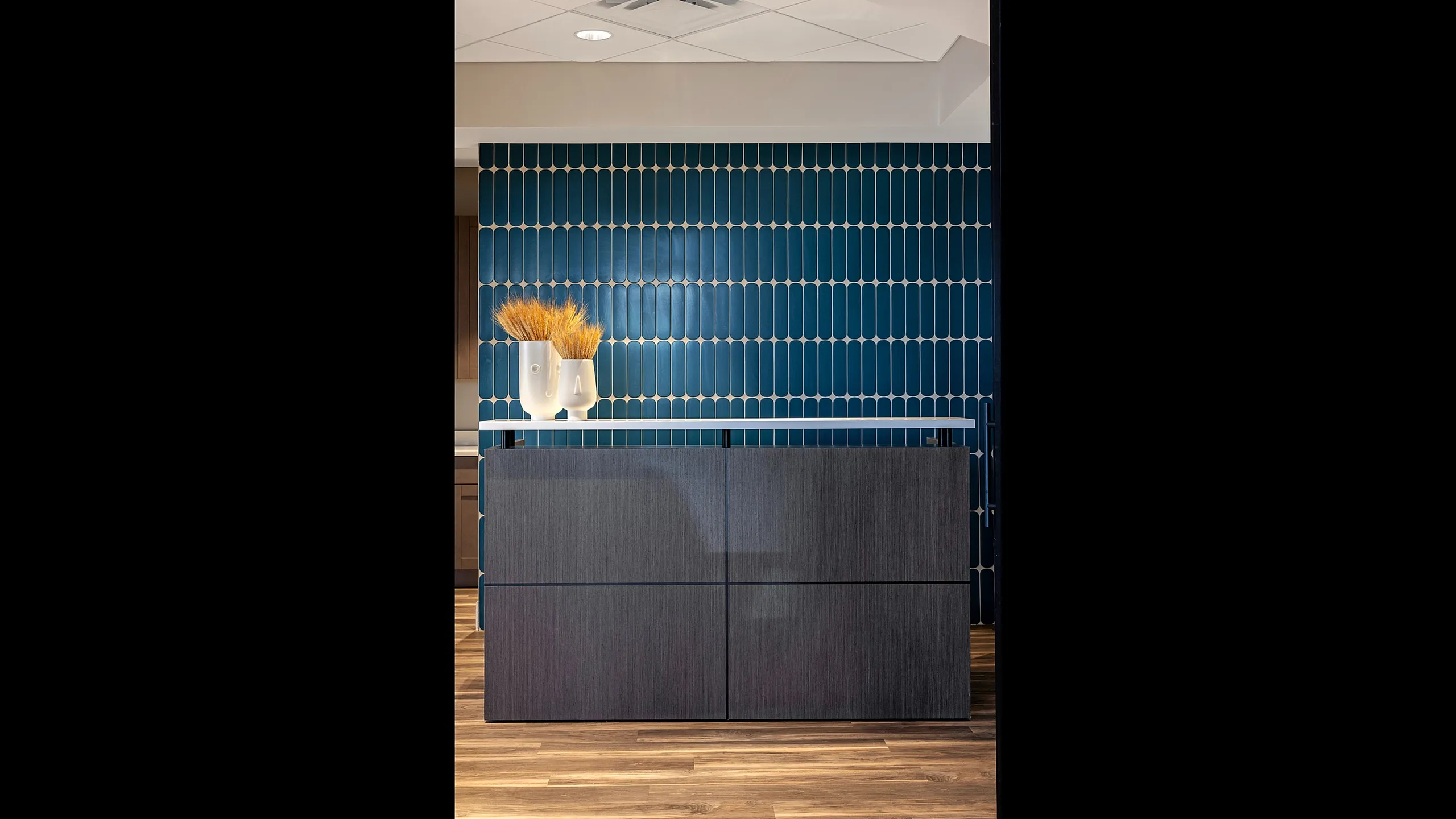 Elegant reception space with modern blue tiled wall and stylish decor.