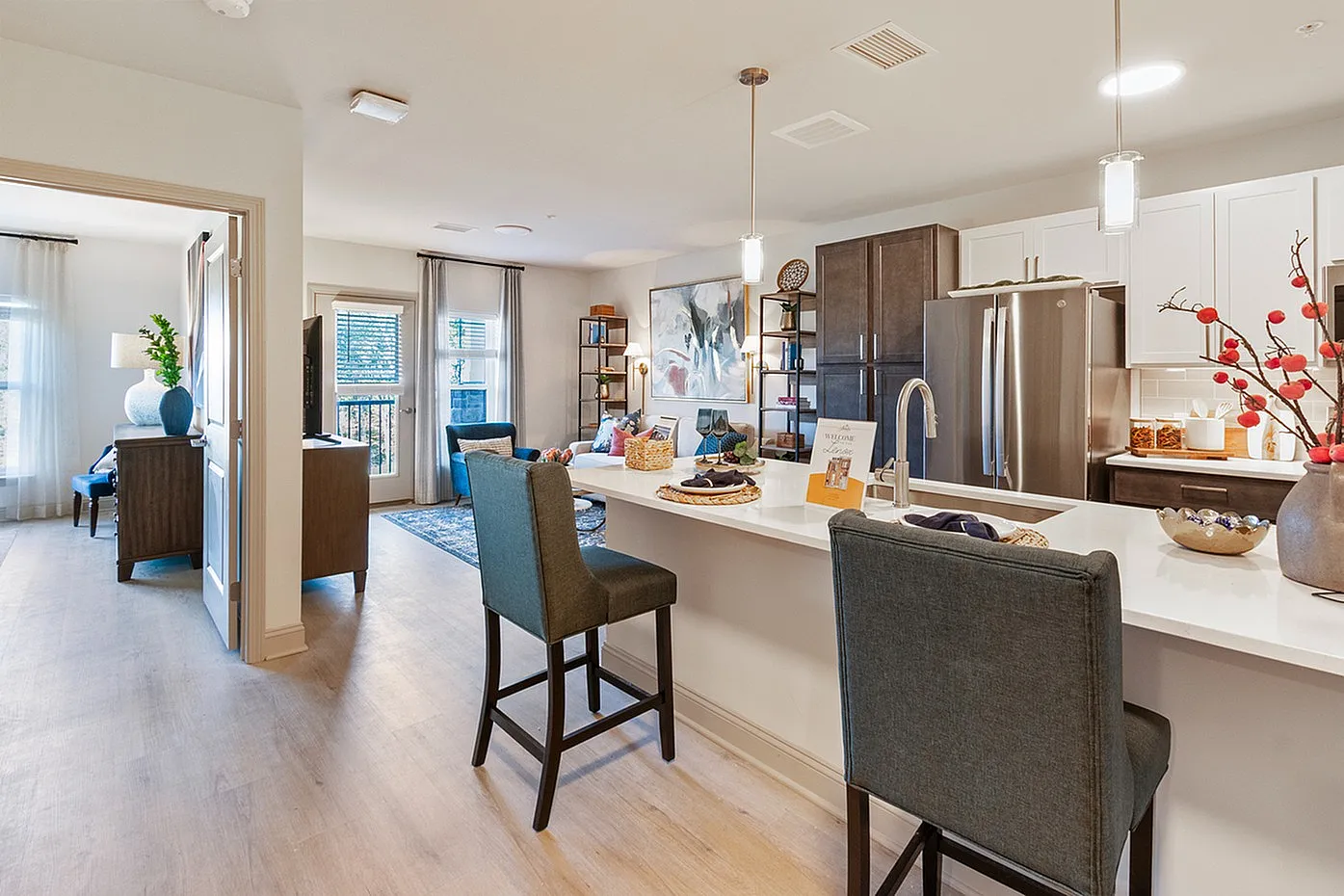 Modern open-concept living area with a sleek kitchen and stylish décor, welcoming natural light and a cozy atmosphere.