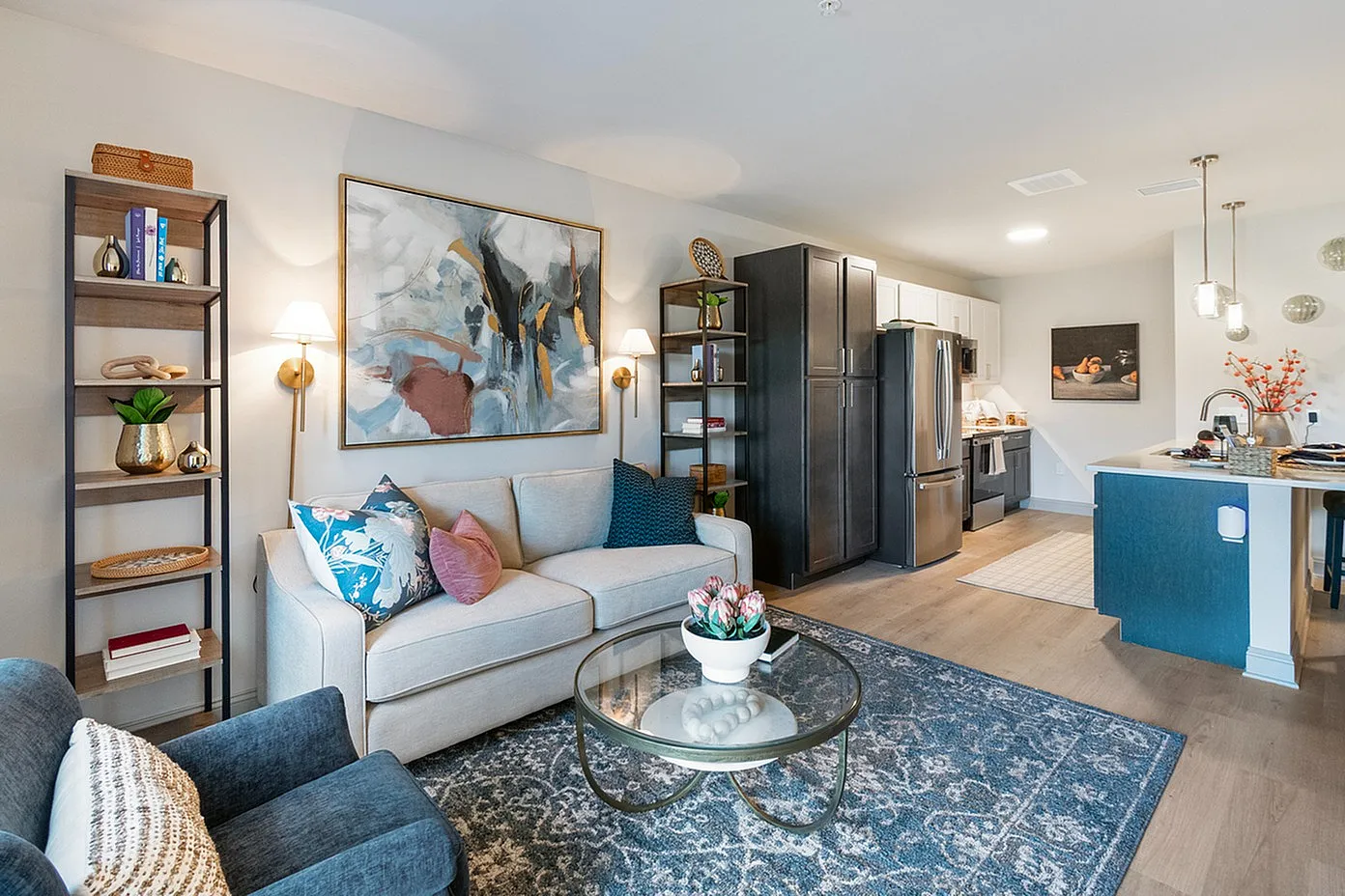 Chic open-concept living room and kitchen with modern decor, elegant furnishings, and luxurious finishes, creating an inviting and stylish atmosphere.