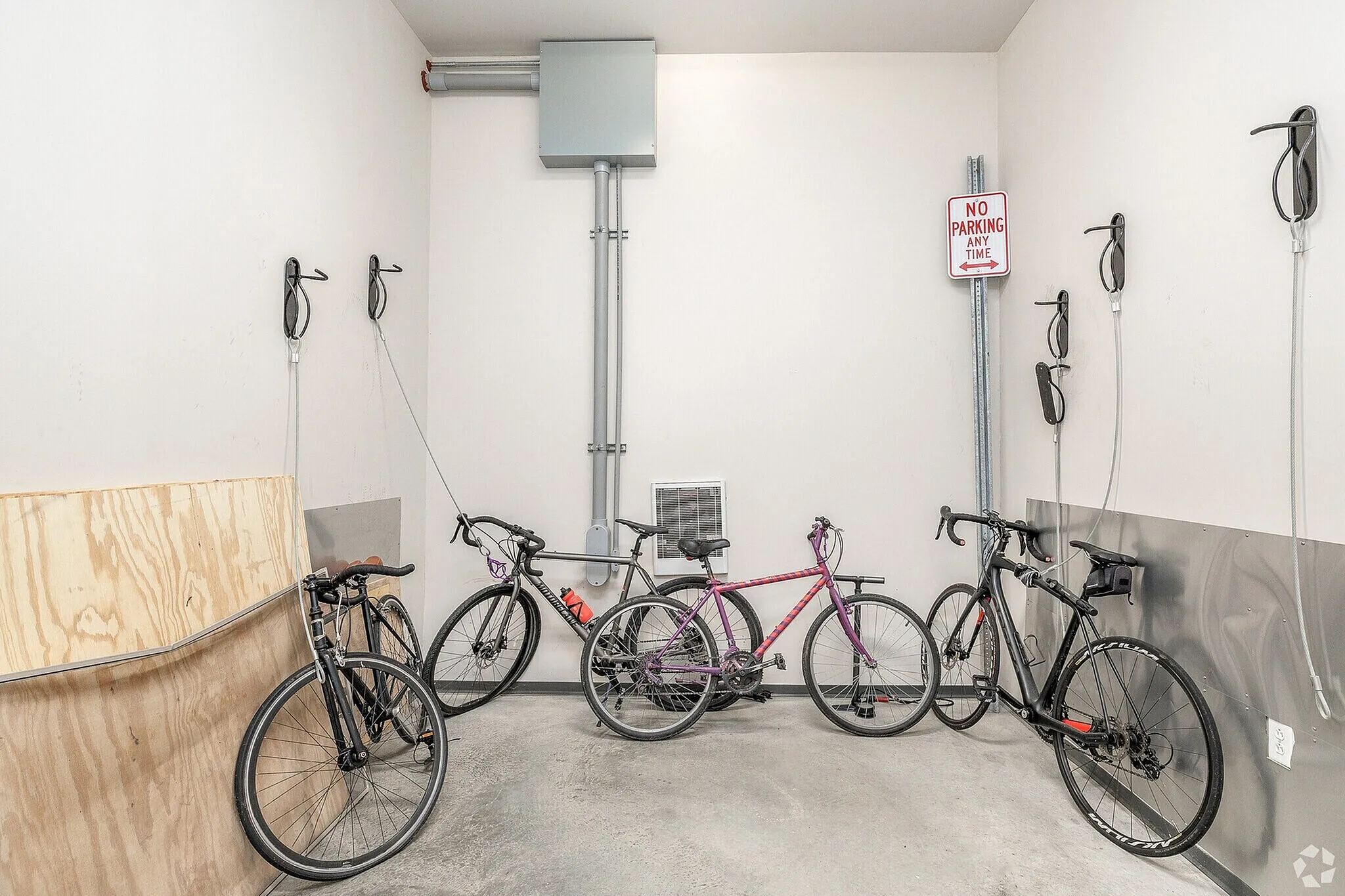 Modern apartment bicycle storage with sleek racks and multiple bike options, ideal for cycling enthusiasts.