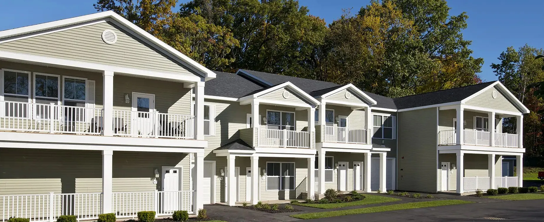 Panoramic image of the front of a green Kensington apartment building