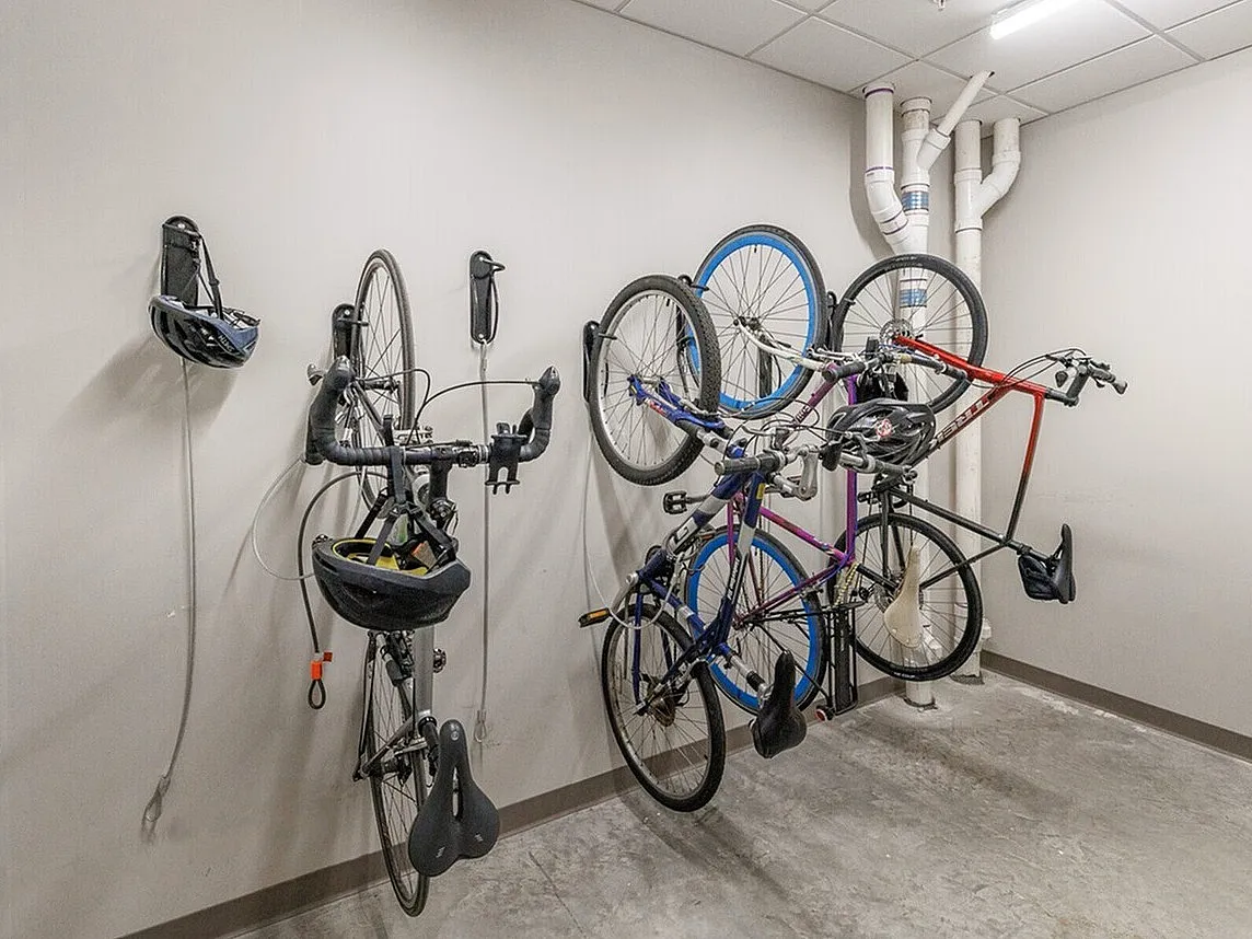 Modern bicycle storage room with sleek wall-mounted racks, ideal for urban living spaces.