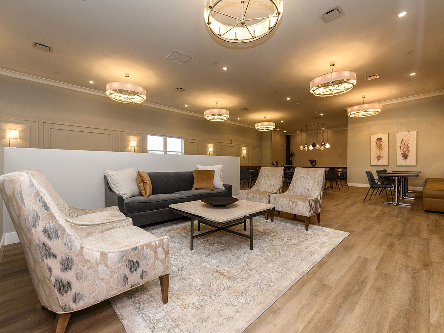 Elegant open space living area with stylish modern decor, featuring comfortable seating, chic lighting, and a warm ambiance.