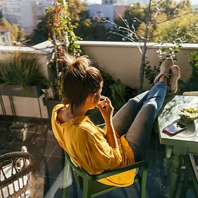 Charming balcony retreat with lush greenery, perfect for enjoying a relaxing morning coffee.