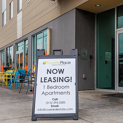 Modern Fayette Place apartments offering vibrant one-bedroom units now leasing, featuring colorful outdoor seating and urban convenience.