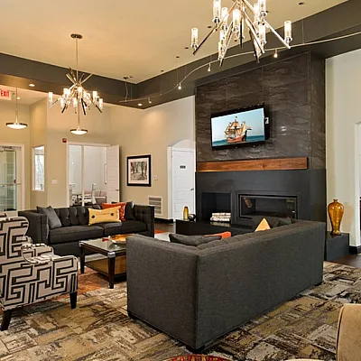 Luxurious open-concept club house interior with modern decor and stylish chandeliers.