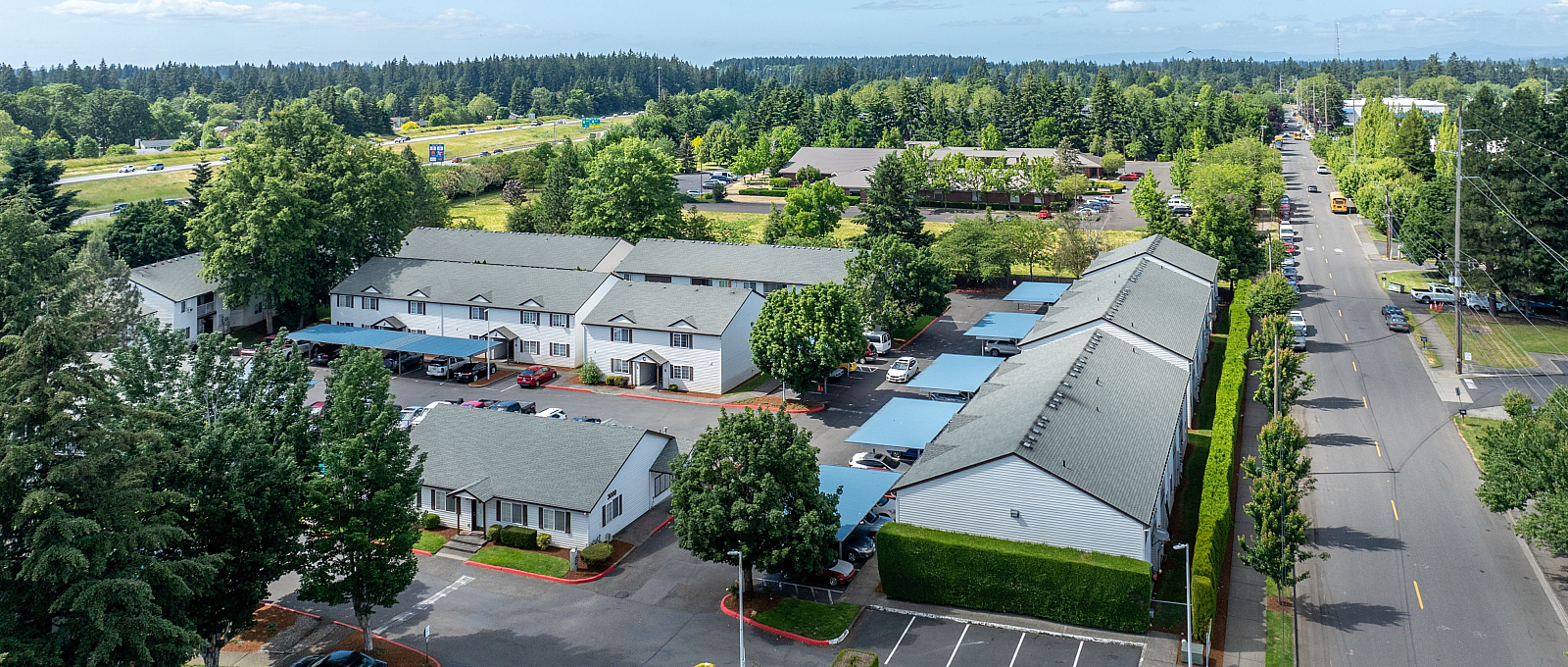 Charming community with lush greenery and spacious parking, offering serene surroundings and modern living spaces.