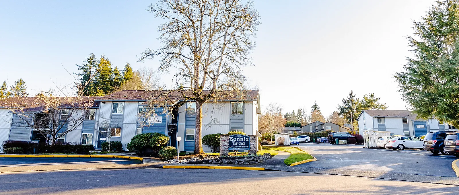 Charming residential community with modern apartments and lush greenery, offering convenient parking and serene surroundings.
