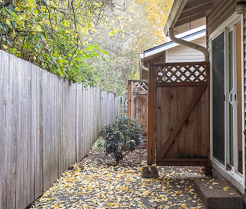 Charming outdoor space with a rustic wooden fence and lush greenery, perfect for a tranquil retreat.