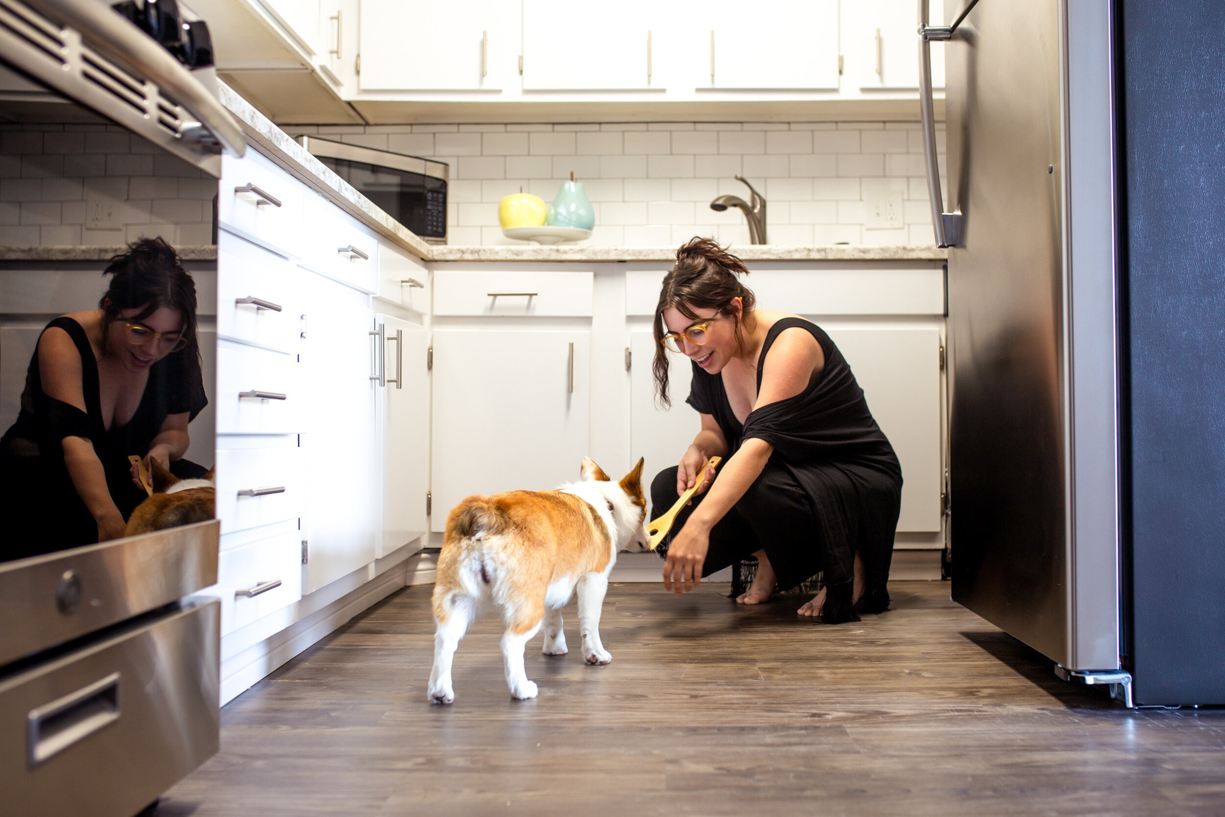 Woman feeding dog in pet friendly apartment Little Rock