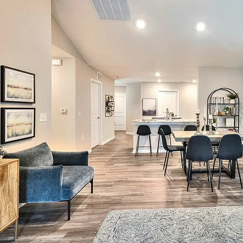 Bright and airy open-concept living area with modern furnishings and elegant dining setup.