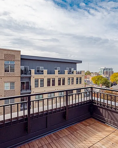 Chic urban balcony with modern railing offers stunning views of city landscape and vibrant skyline.
