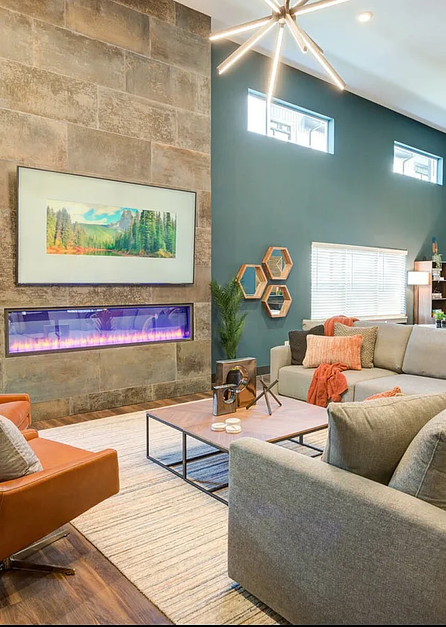 Elegant living room with modern fireplace, plush sectional sofa, and stylish decor creating a cozy ambiance.