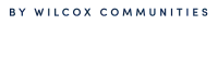 The Thomas by Wilcox Communities logo in elegant dark blue typography on a light background.