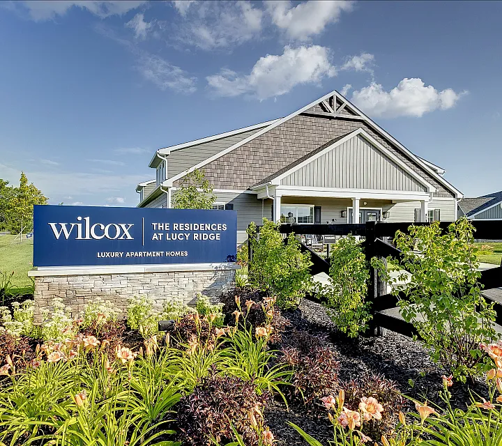 Charming luxury apartment entrance with lush landscaping and elegant architecture at The Residences at Lucy Ridge.