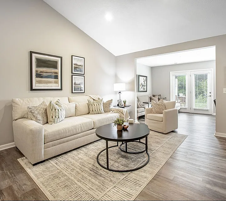 Bright and inviting living room with modern decor, elegant furniture, and natural light streaming through large windows.