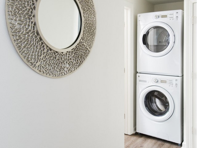 Stacked washer and dryer in apartment at The Flatts Salisbury | Apartments In Salisbury, MD.