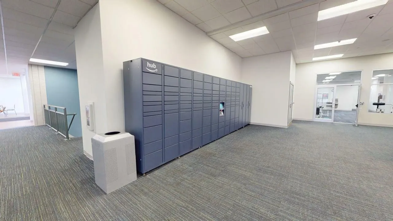 Modern communal space featuring sleek package lockers and bright overhead lighting, offering convenience and style.