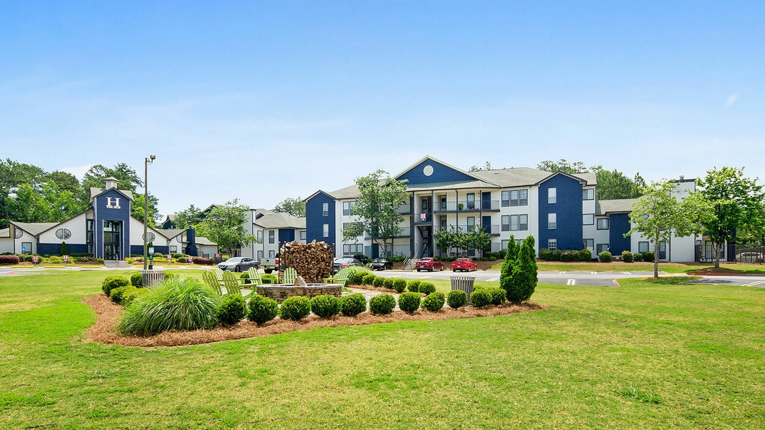 Beautiful apartment complex with landscaped gardens and spacious outdoor seating area.