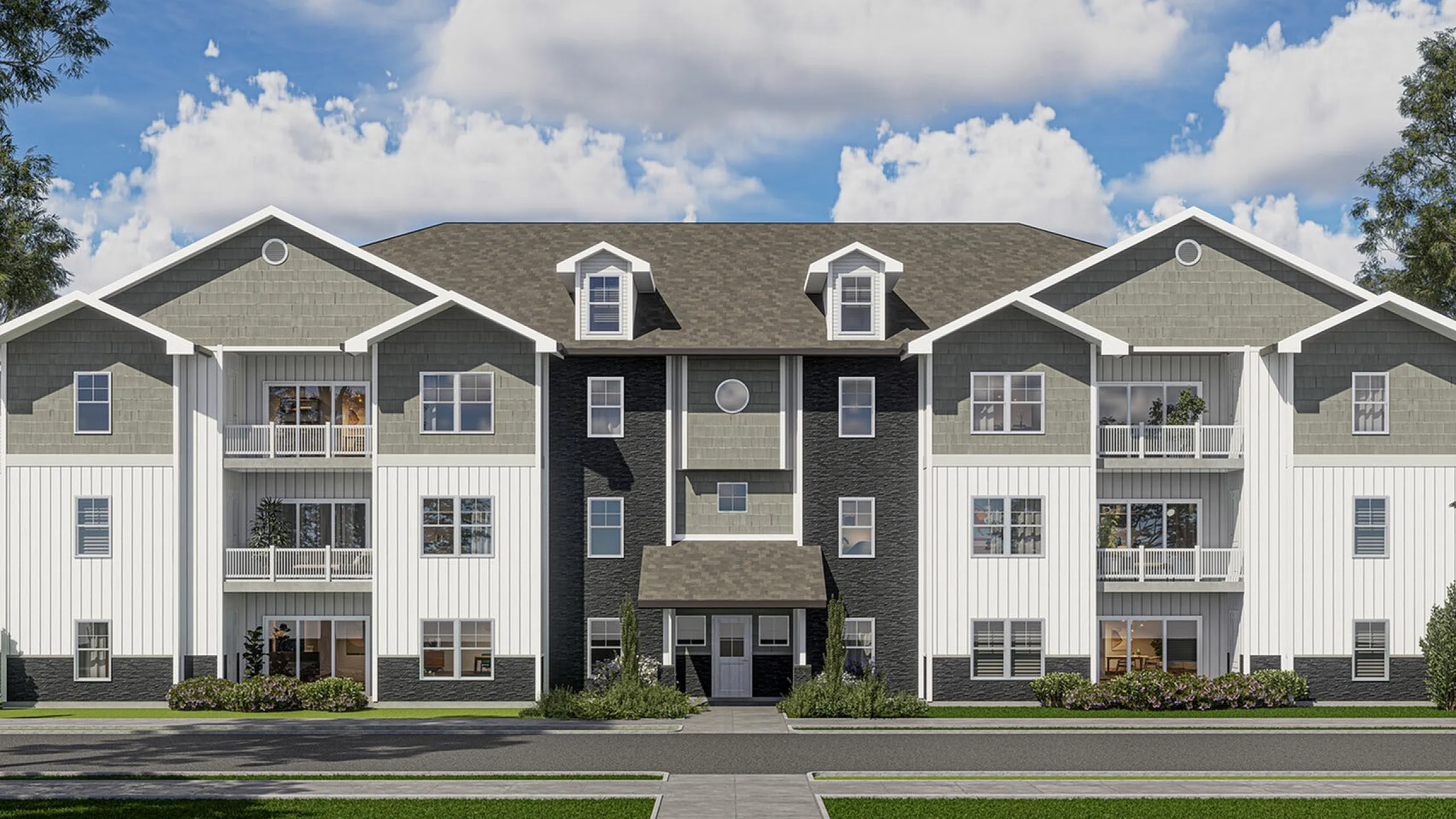 Charming triplex apartment building with modern gabled roofs and inviting balconies surrounded by lush greenery under a vibrant blue sky.