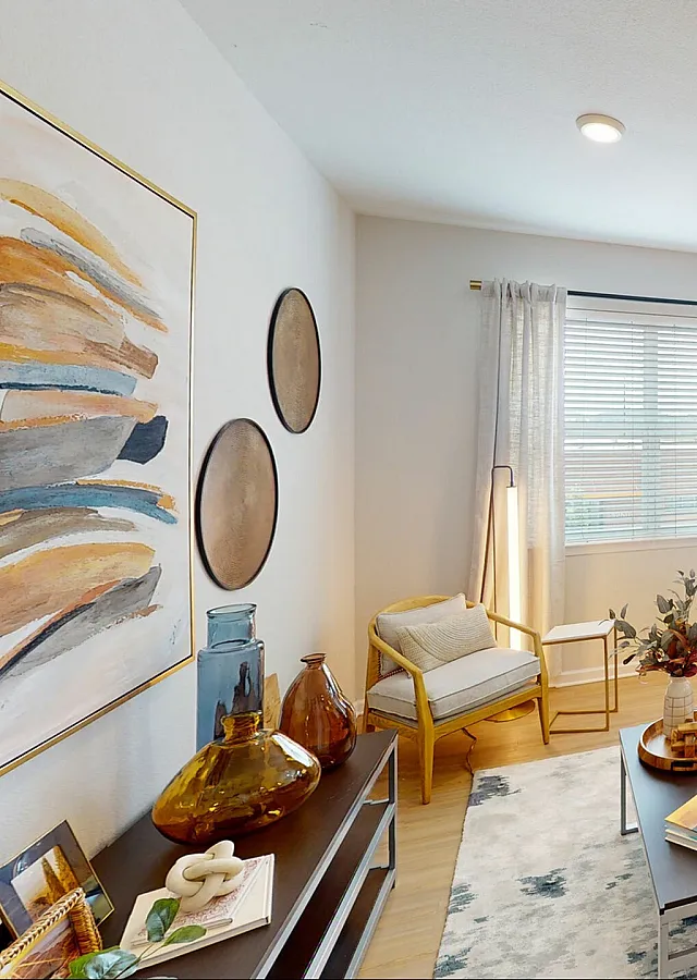 Inviting open-concept living room with modern decor, cozy seating, and abundant natural light. Perfect for relaxation and entertaining.