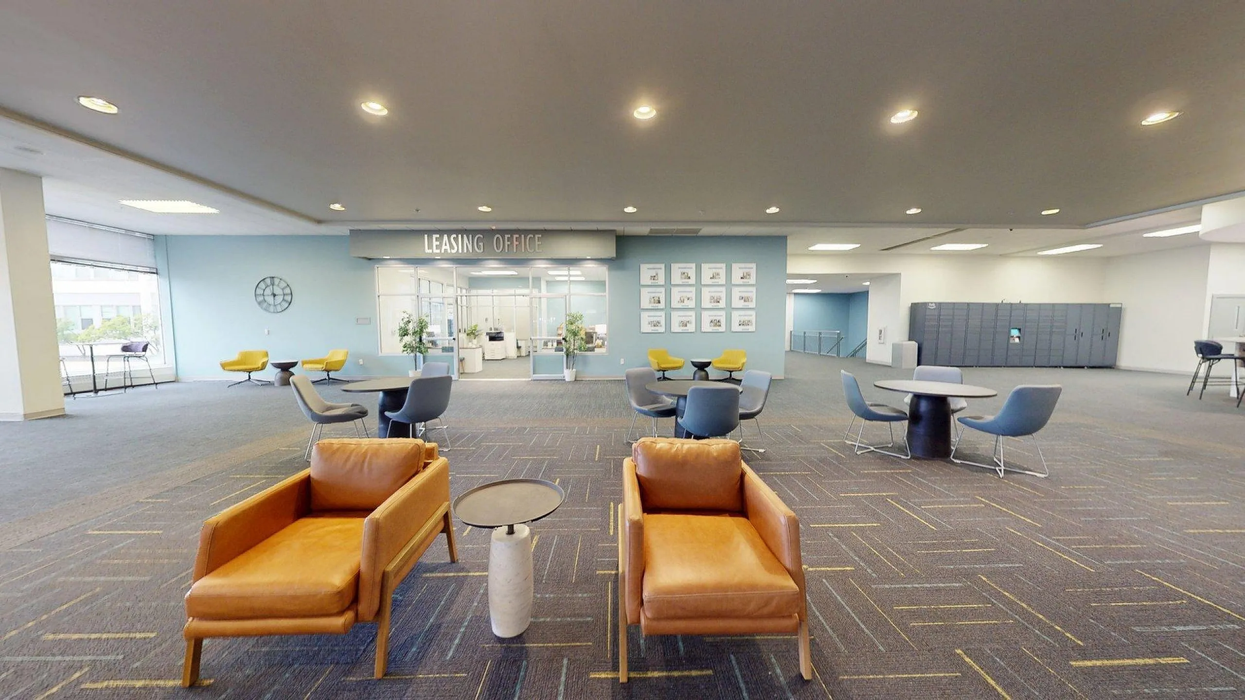 Modern leasing office with stylish lounge seating and vibrant decor offers a welcoming atmosphere.
