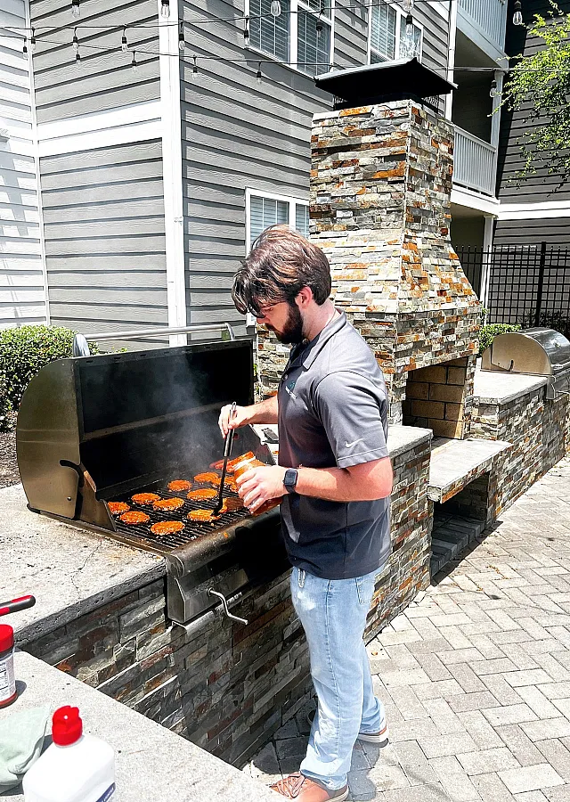 Inviting outdoor grilling station with modern stone BBQ area, perfect for hosting gatherings and enjoying sunny days.