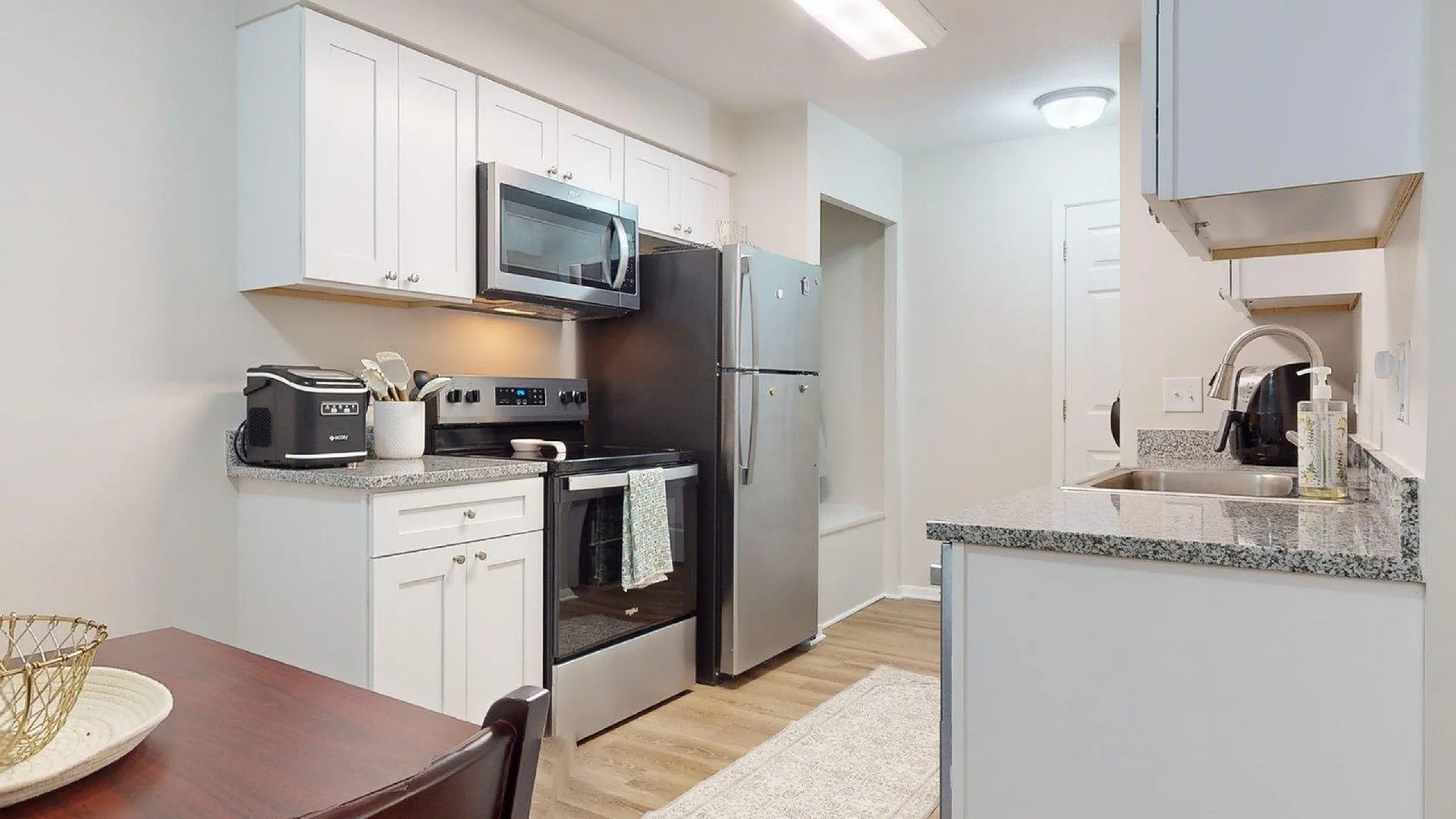 Contemporary kitchen with sleek stainless steel appliances, granite countertops, and elegant cabinetry, offering a stylish and functional cooking space.