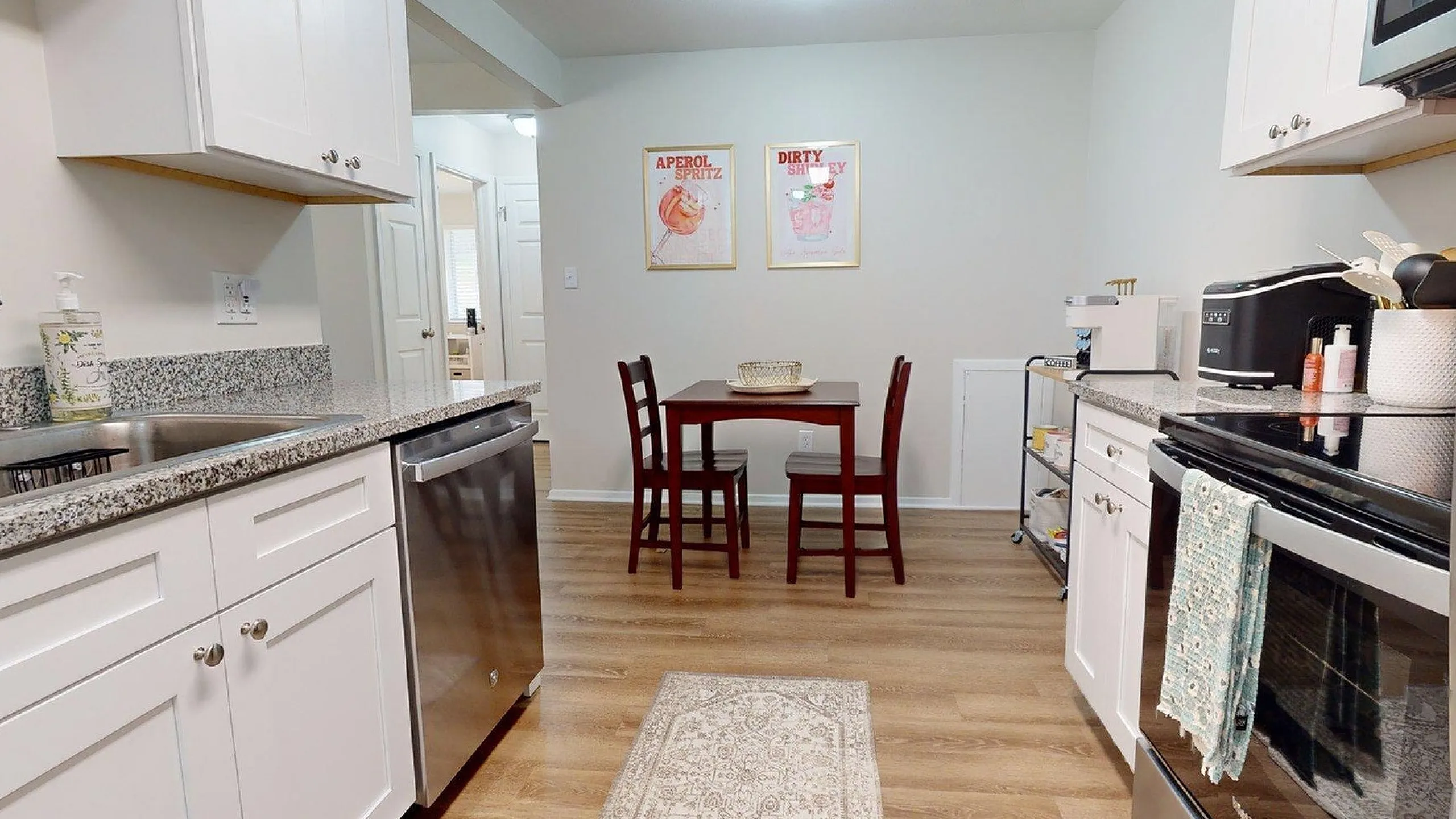 Bright and welcoming kitchen with modern stainless steel appliances, elegant granite countertops, and a cozy dining area.