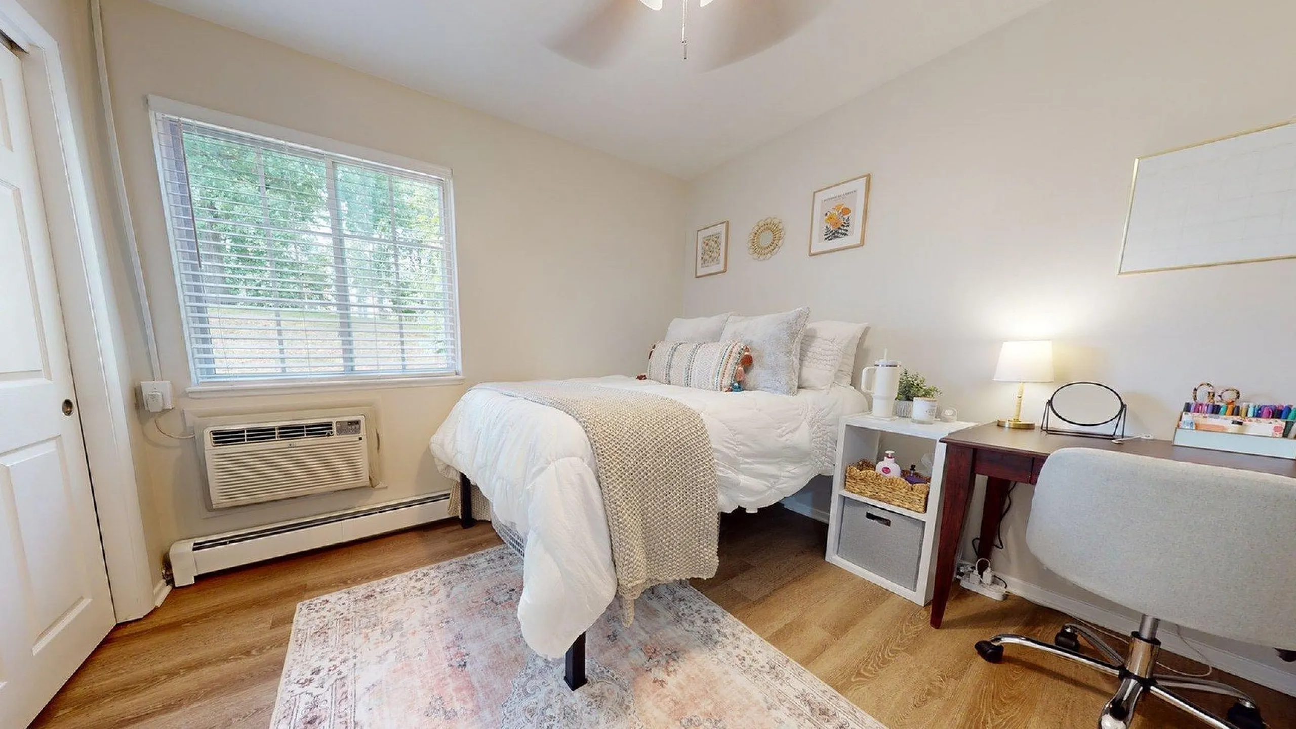 Cozy bedroom showcasing a plush bed, stylish desk, and soft natural lighting for a serene atmosphere.
