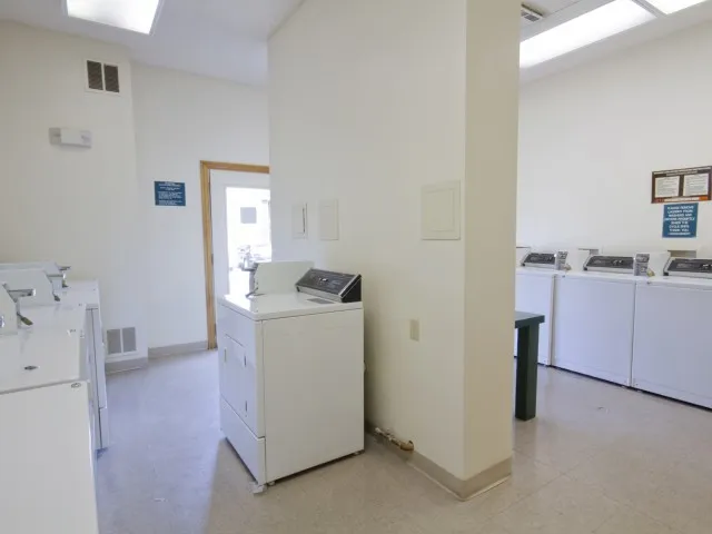 on-site laundry room at Willow Creek Apartments, showing open layout and ample machines.