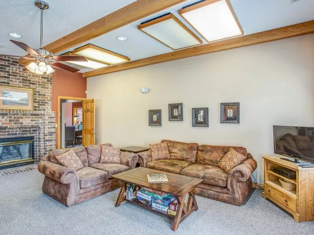 Comfortable resident lounge at Willow Creek Apartments featuring soft couches, rustic d&eacute;cor, and a welcoming atmosphere for residents.