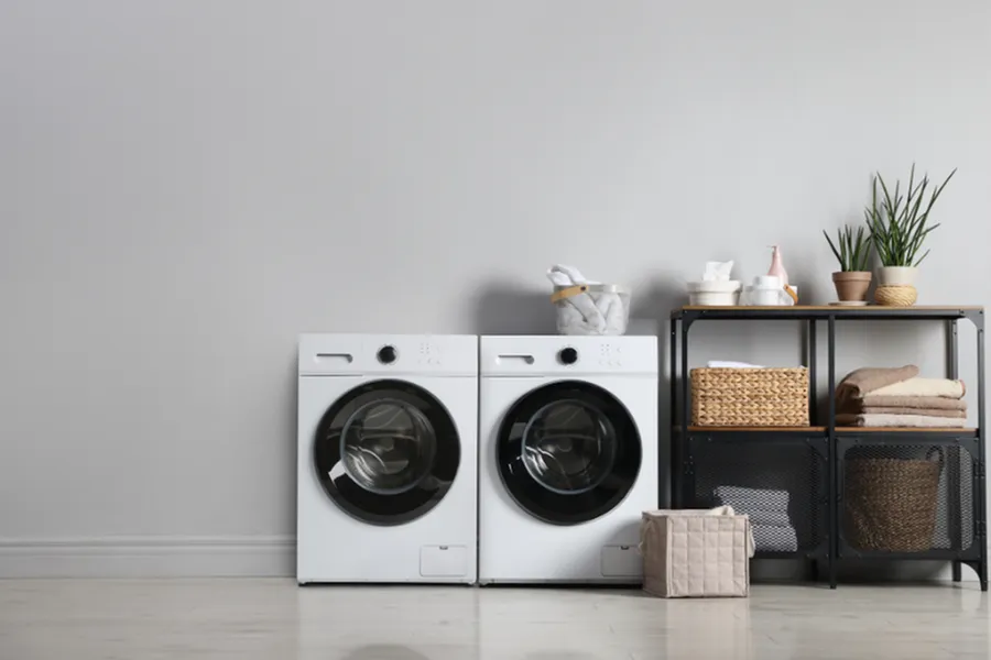 Sleek laundry room with modern washer and dryer, stylish storage solutions, and elegant decor enhancing functionality and aesthetics.