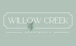 Logo for Willow Creek Apartments in Springfield, MO. Features elegant white serif text on a muted sage green background, with a decorative willow tree graphic integrated into the letter 