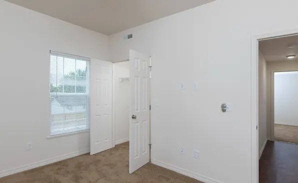 Second bedroom with closet and window providing natural light, located in a Springfield, MO apartment.