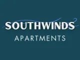 Logo for Southwinds Apartments featuring bold white text and a flowing blue line, evoking a breezy, coastal theme on a deep teal background.