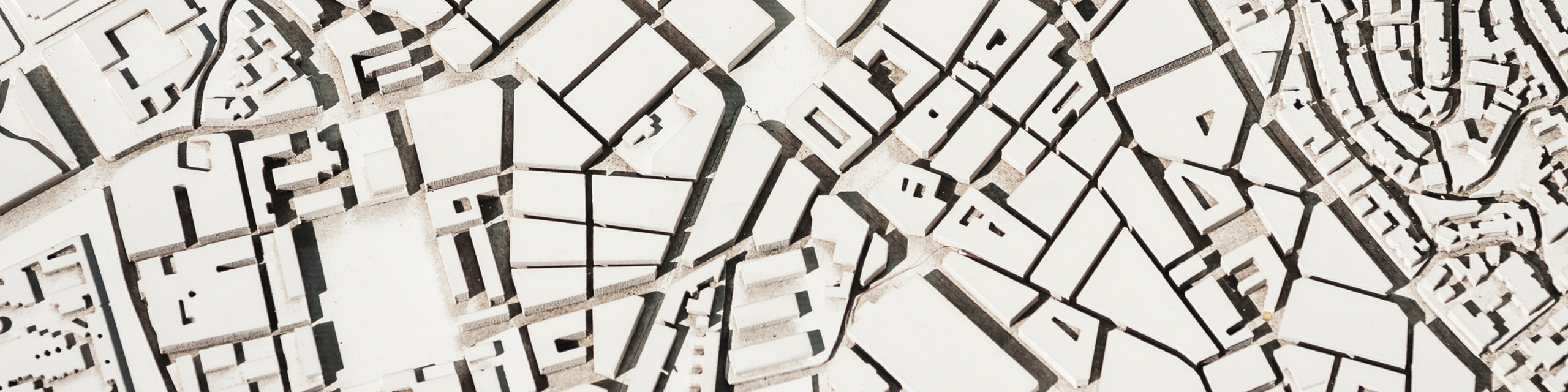Intricate architectural map model with detailed city layout, highlighting modern urban design.
