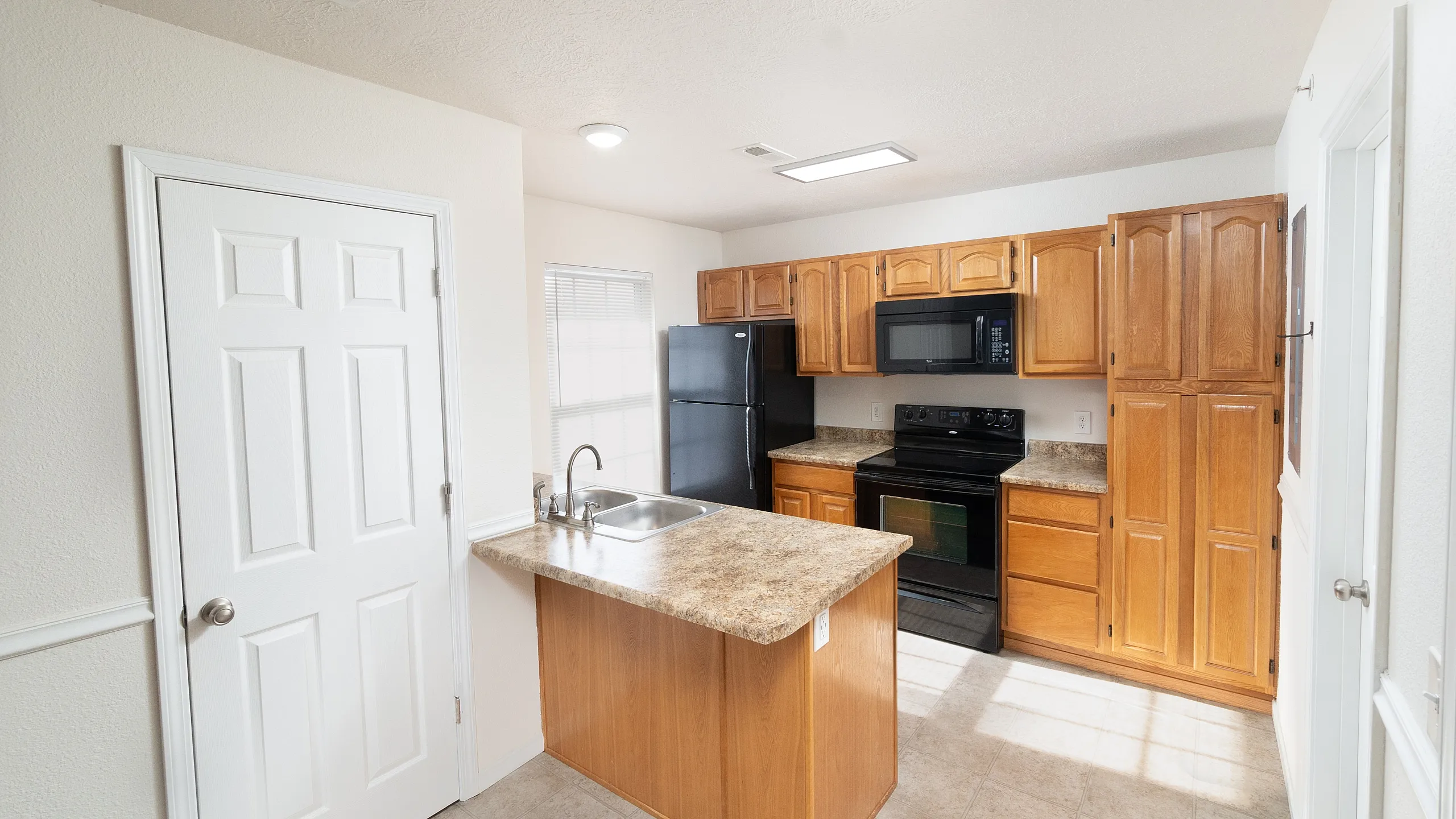 Bright, modern kitchen with wooden cabinetry, sleek countertops, and energy-efficient appliances.