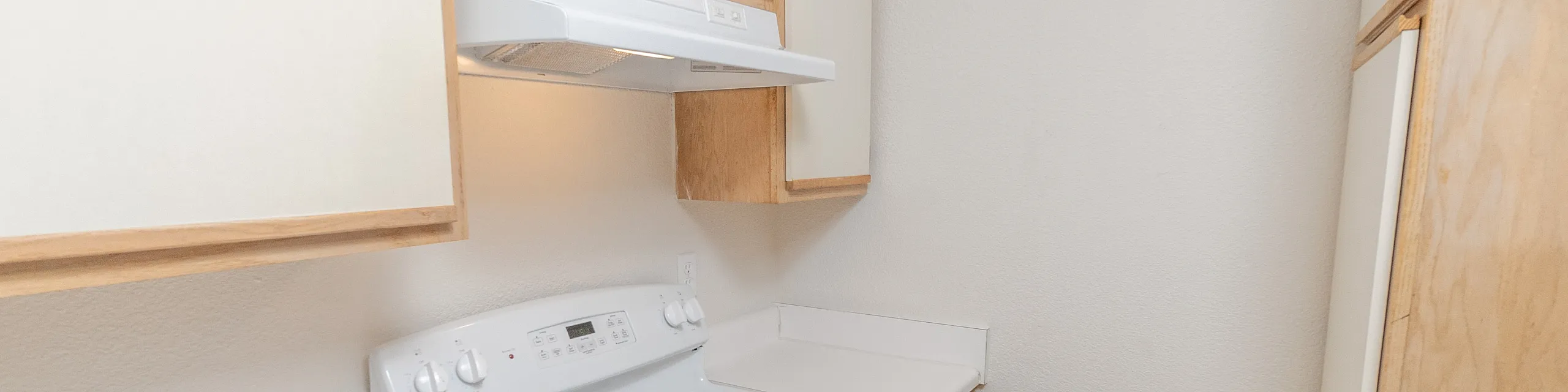 Cozy kitchen with modern white appliances, sleek countertops, and ample cabinet space for a streamlined cooking experience.