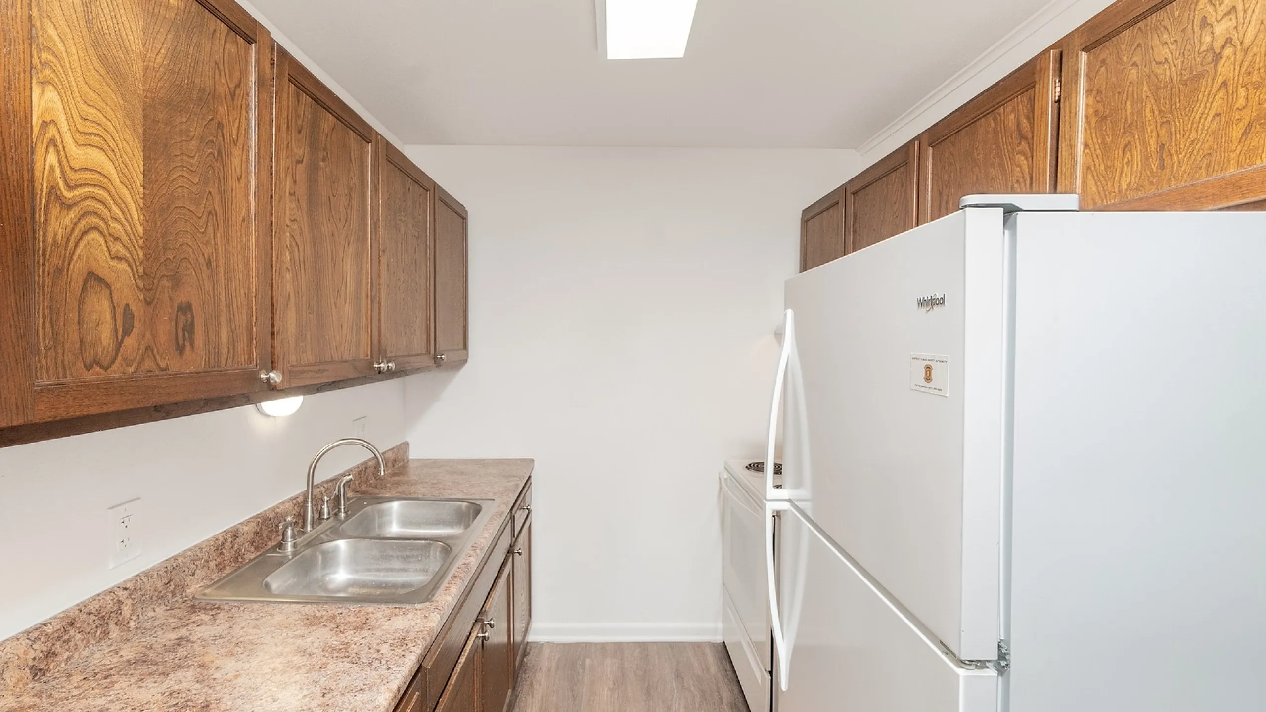 Bright, modern kitchen with sleek countertops, classic wooden cabinets, and high-quality appliances, perfect for culinary creativity.