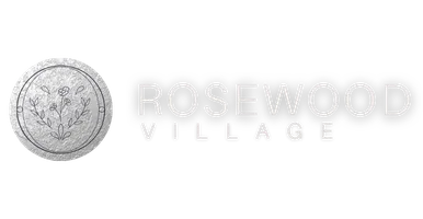 Rosewood Village logo featuring bold white &ldquo;ROSEWOOD&rdquo; lettering above spaced &ldquo;VILLAGE&rdquo; text on a transparent background.