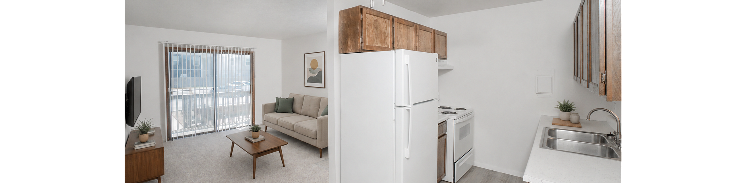 Bright open-concept apartment with cozy living room, ceiling fan, and modern kitchen featuring wooden cabinets and white appliances.