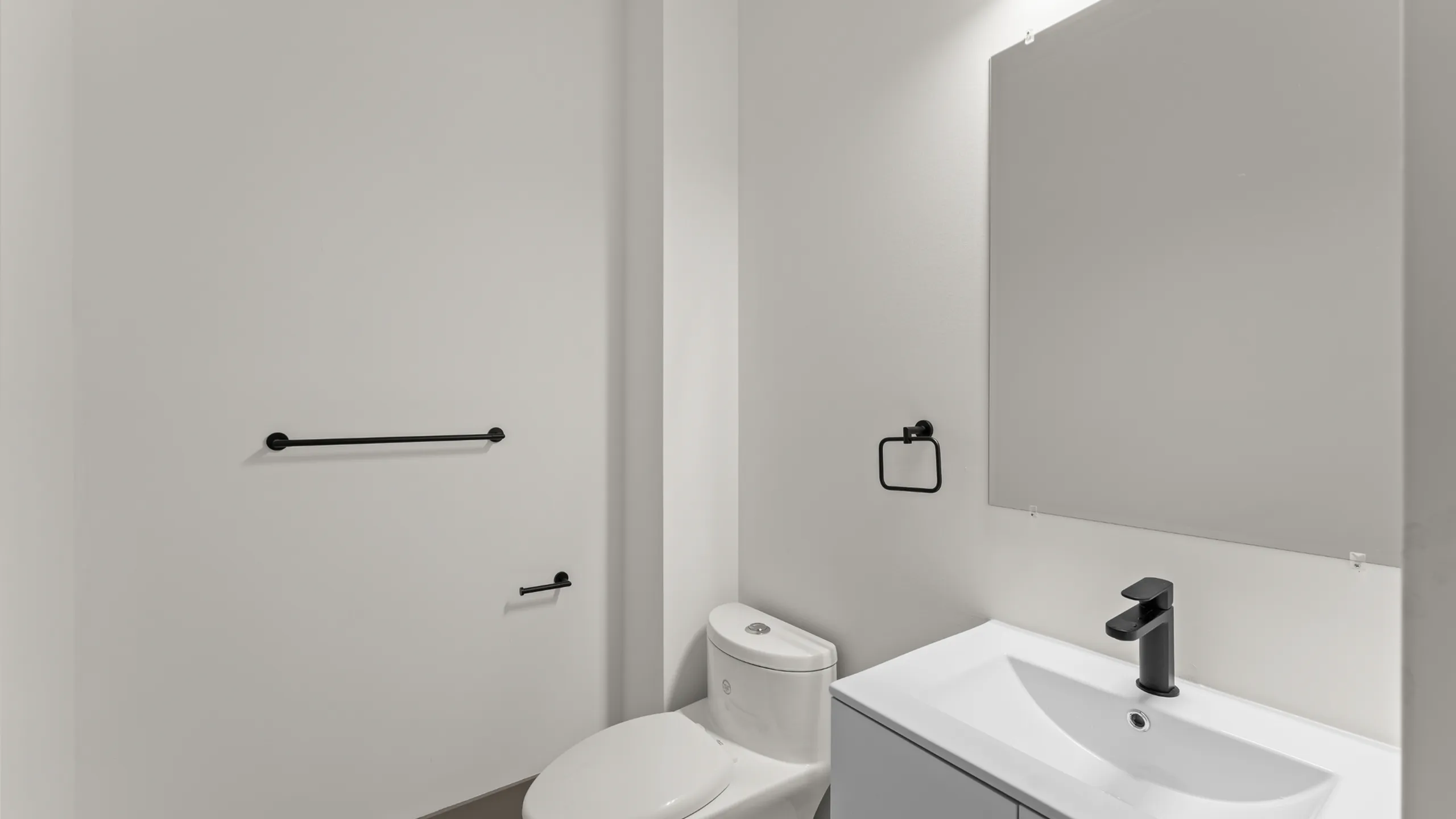 Sleek modern bathroom with elegant fixtures, spacious vanity, and stylish black accents.