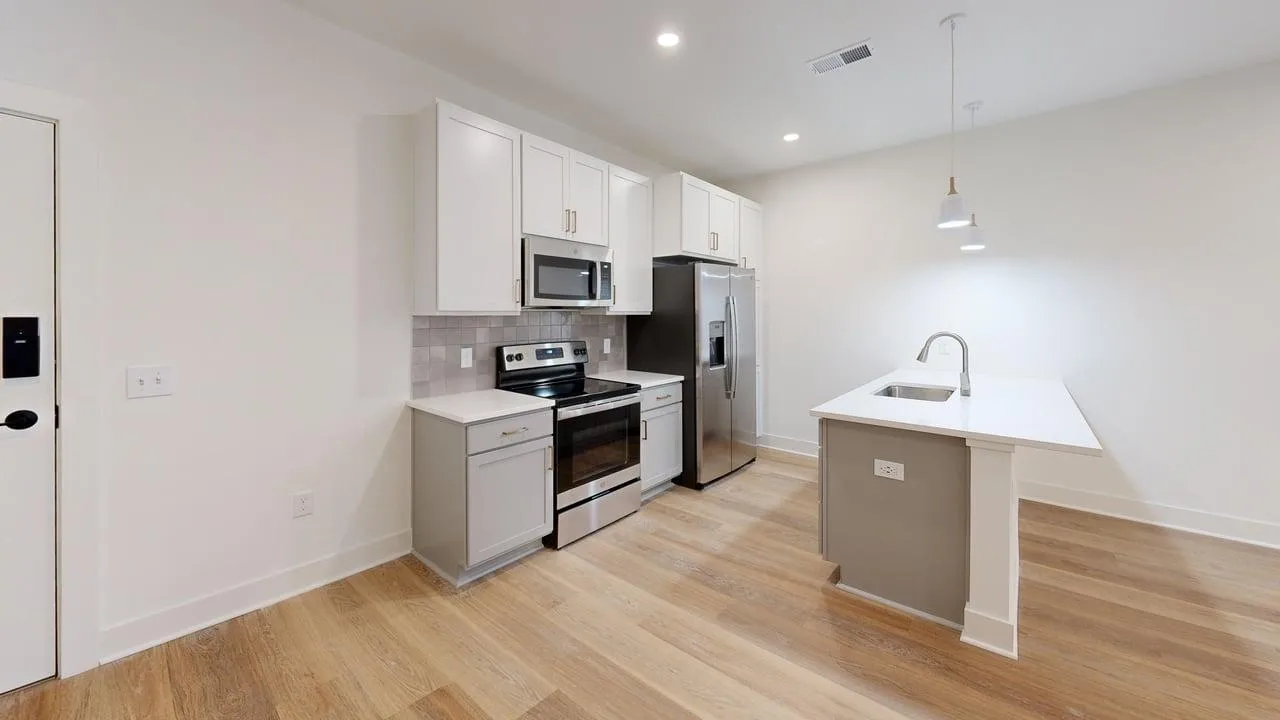 Modern kitchen with sleek cabinetry, stainless steel appliances, and a stylish island with pendant lighting.