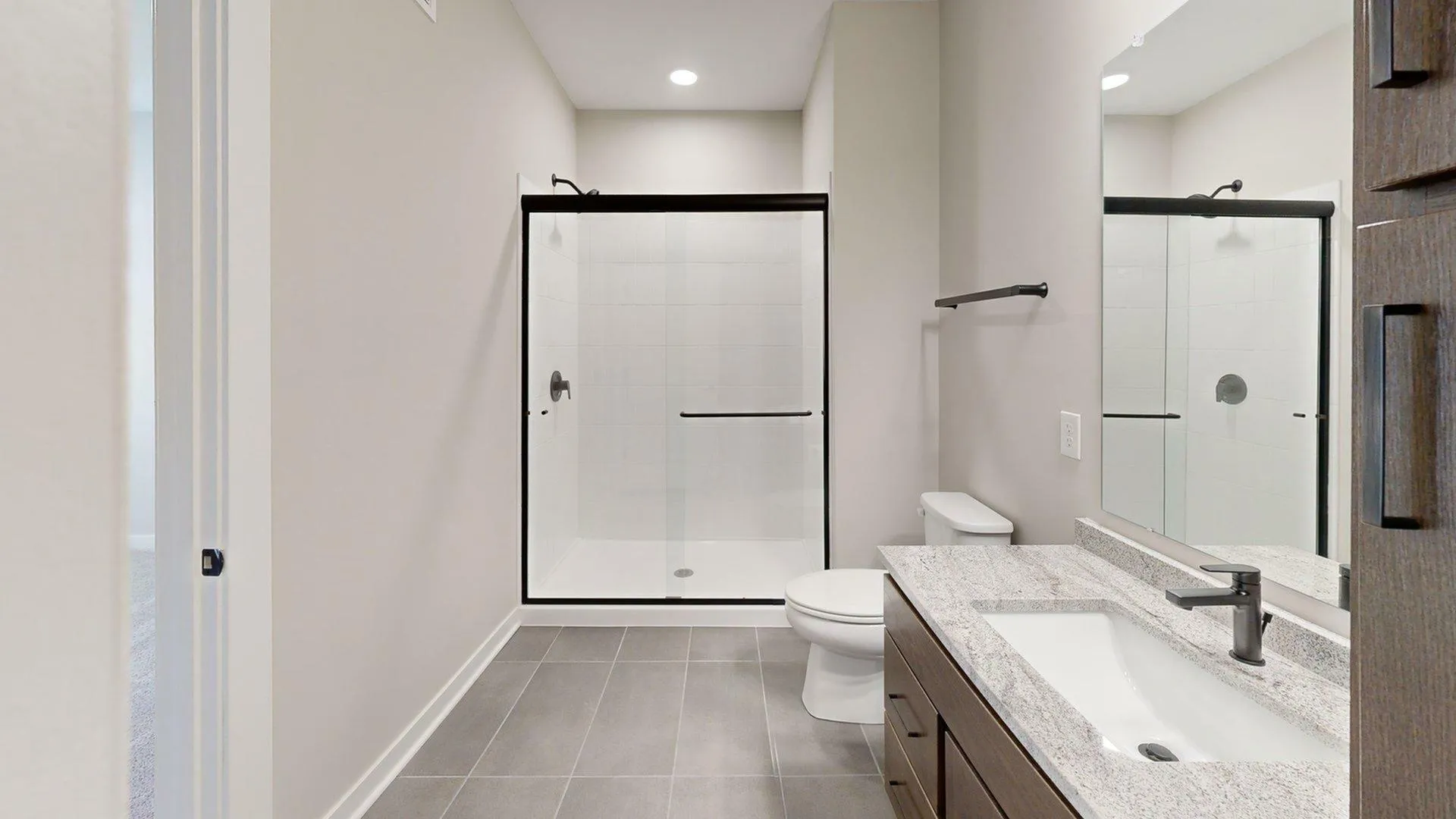 Elegant and modern bathroom with a sleek glass shower, stylish vanity, and polished finishes for a luxurious feel.