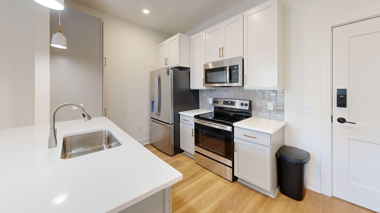 Modern kitchen featuring sleek stainless steel appliances, elegant cabinetry, and a stylish countertop with a built-in sink.