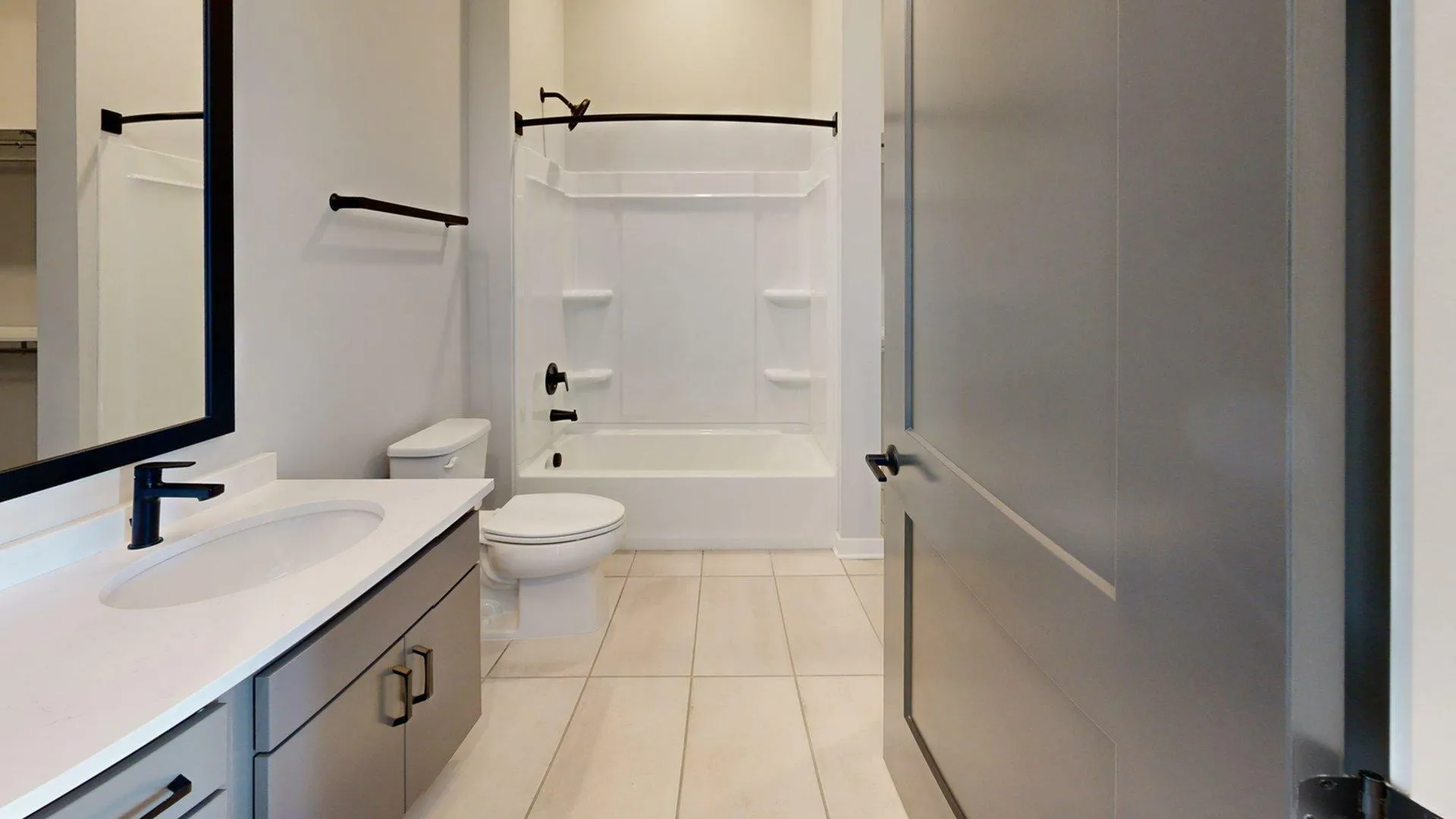 Modern bathroom featuring a sleek vanity, elegant fixtures, and a spacious bathtub with a clean, minimalist design.