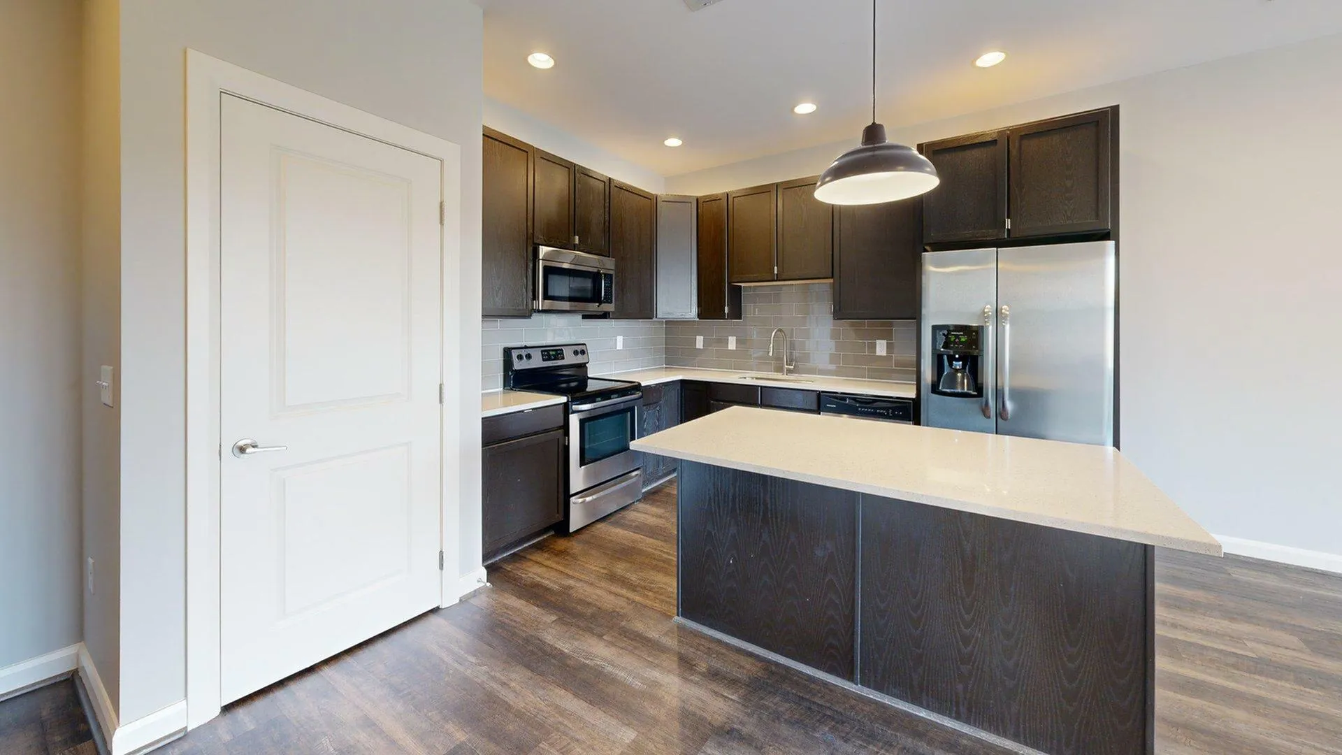 Sleek modern kitchen with stainless steel appliances, elegant cabinetry, and a spacious counter island.